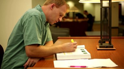 stock-footage-college-student-studying-and-doing-homework-inside-a-library